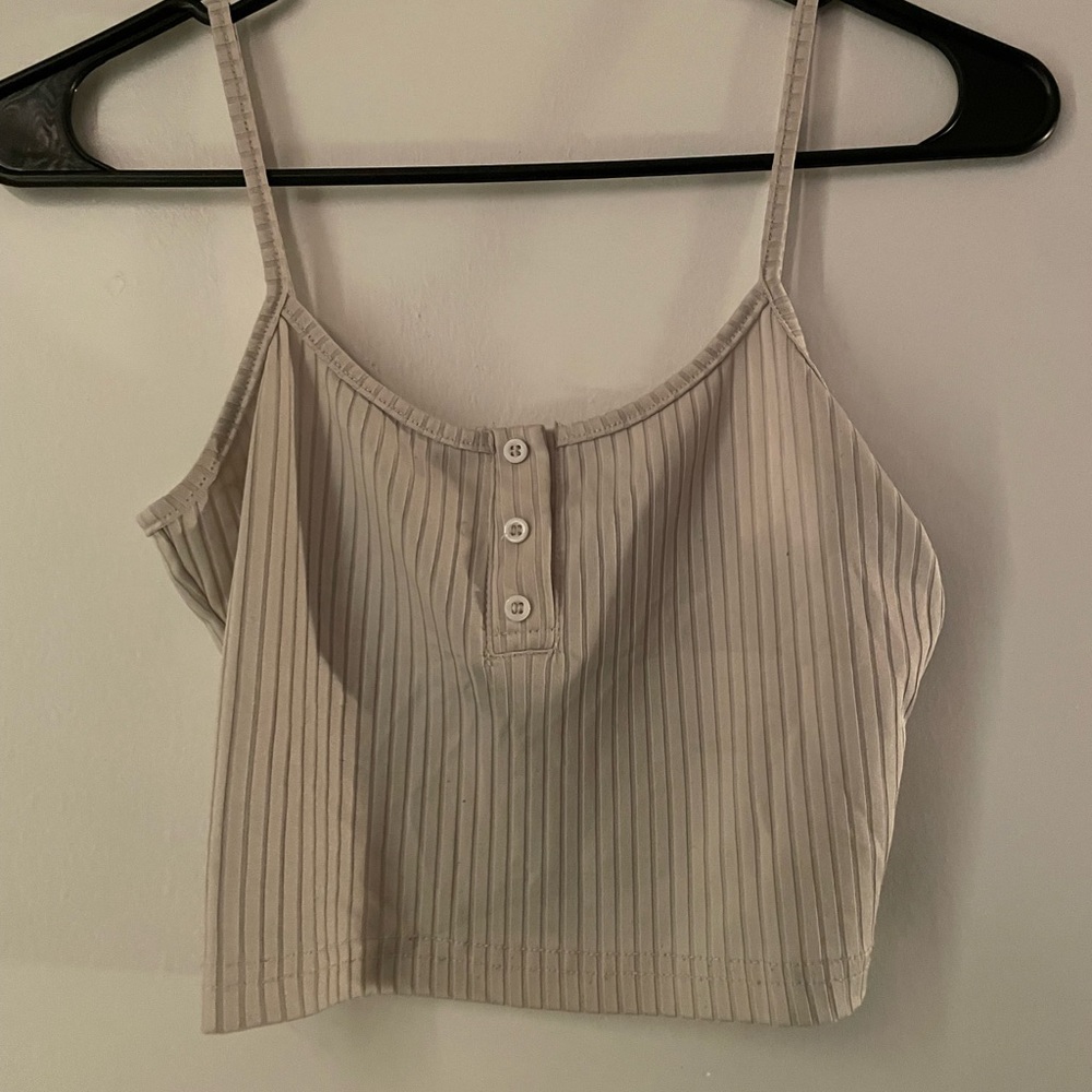 Cute cream colored crop top with buttons.